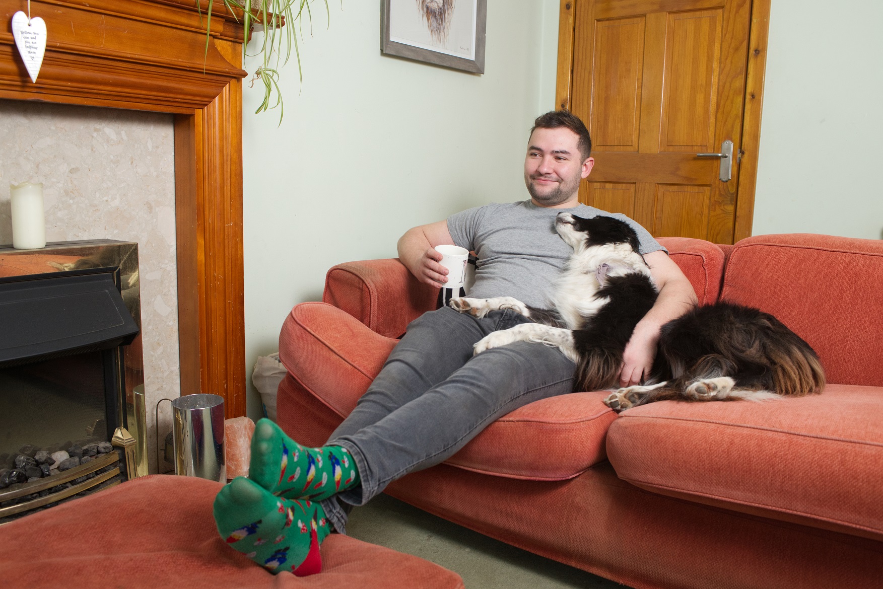 Customer relaxing in rented home with dog