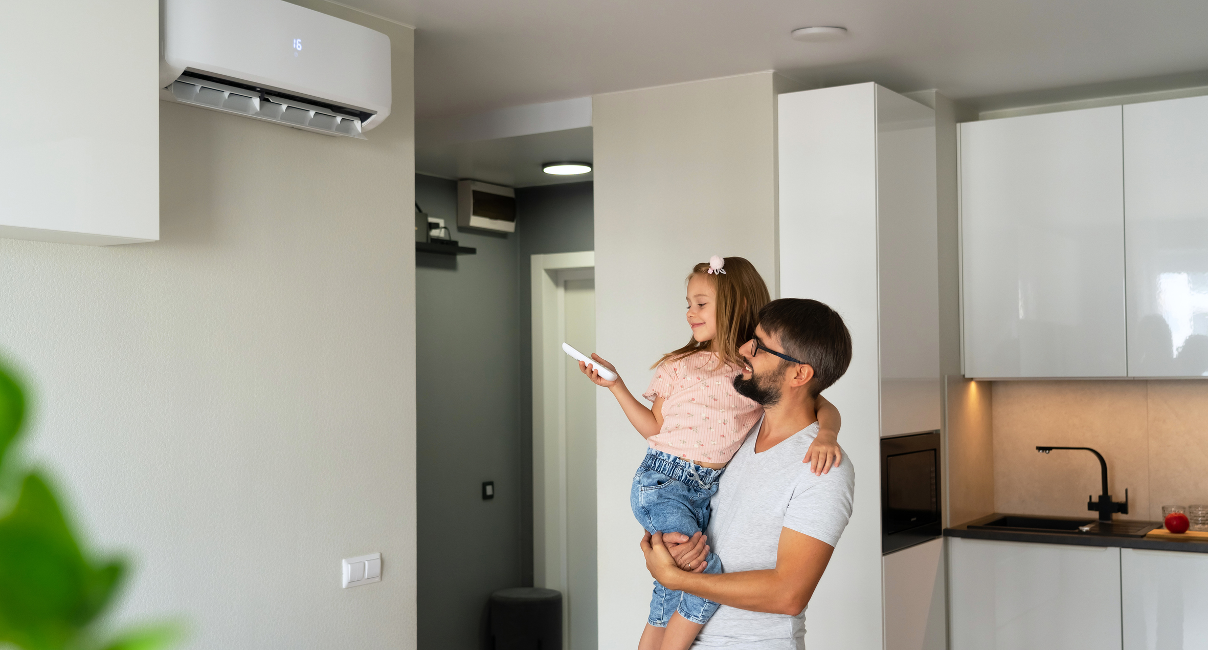 Father helping his daughter to control the heater