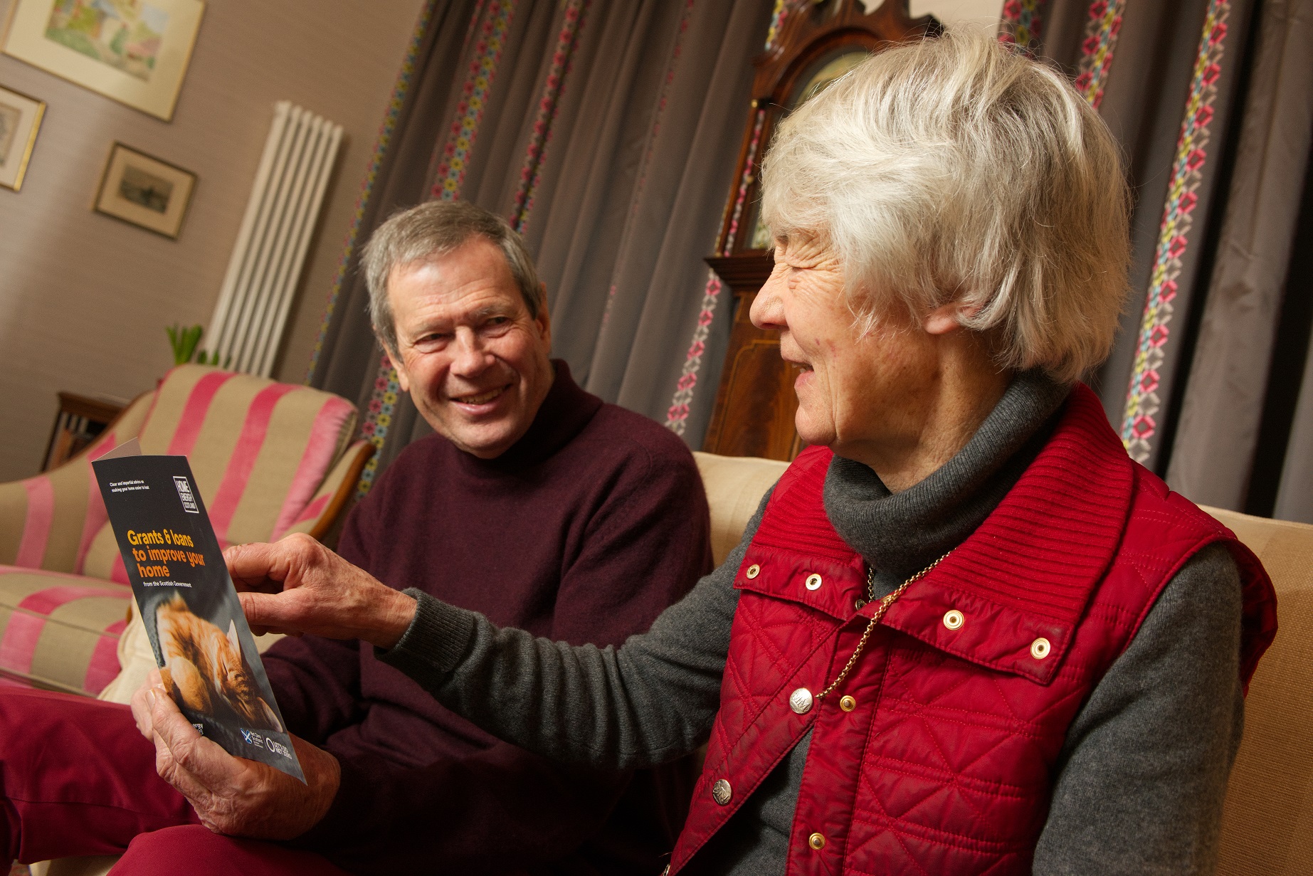 Home Energy Scotland customers reading advice leaflet