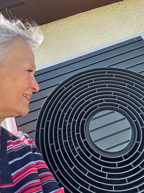 A person looking at a heat pump
