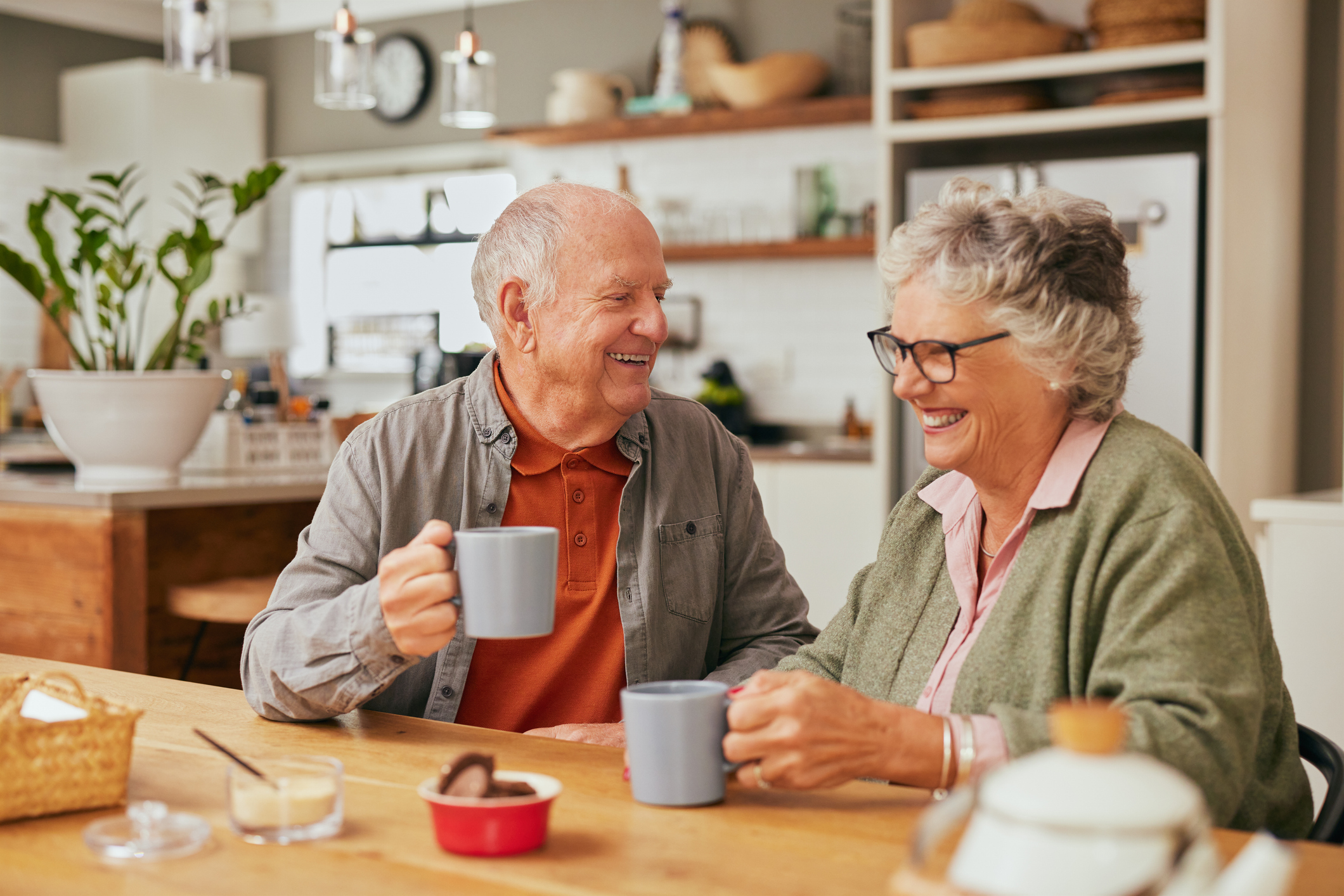 An older couple drinking tea at home