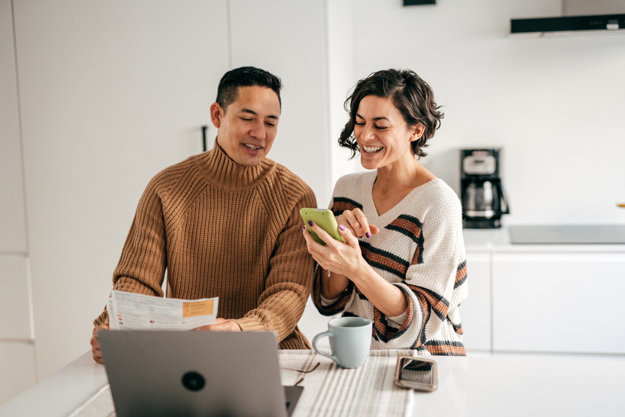 Happy couple using phone