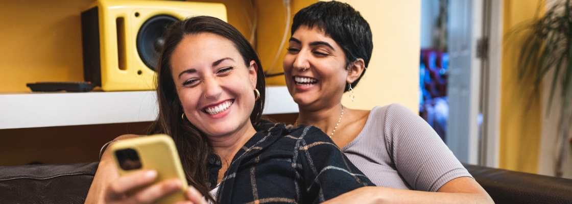 two people smiling at phone