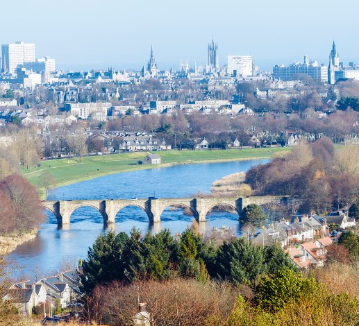 View of the River Dee and a stone bridge with Aberdeen's skyline visible in the background.