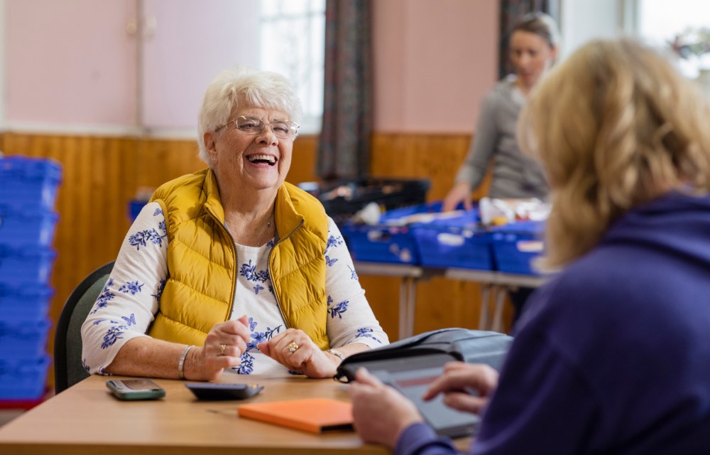 Person talking with an advisor at a community event.