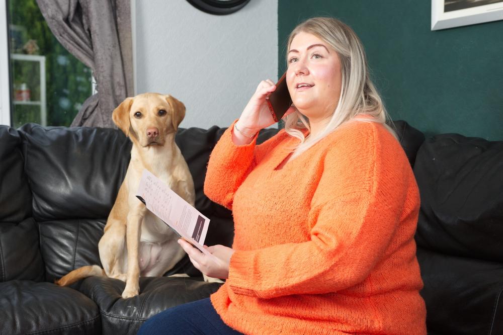 Customer reading a Home Energy Scotland leaflet 