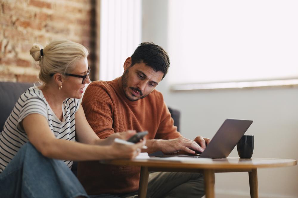 A couple browsing on laptop