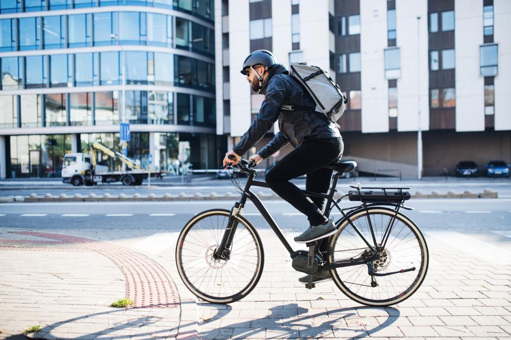 man riding ebike to work
