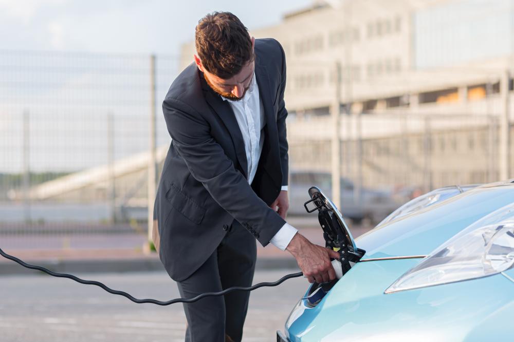 man charging an electric car