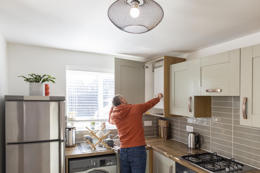 Man adjusting the controls of his boiler