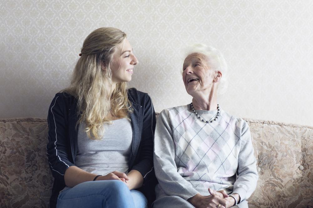 An older and a younger woman sit together