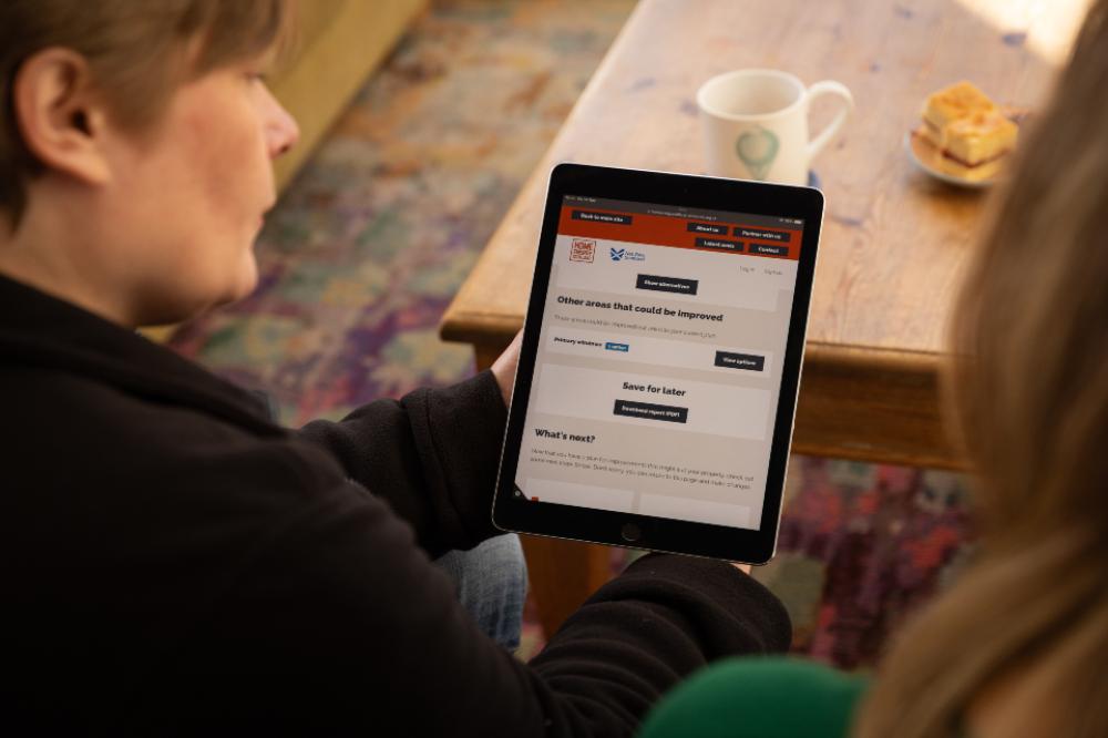 A Home Energy Scotland advisor holding a tablet