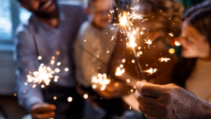Group of people holding sparklers and celebrating new year